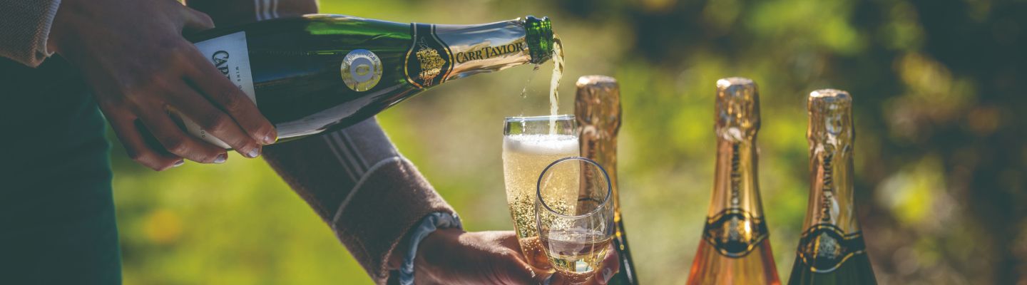A glass of sparkling wine being poured at Carr Taylor Wines